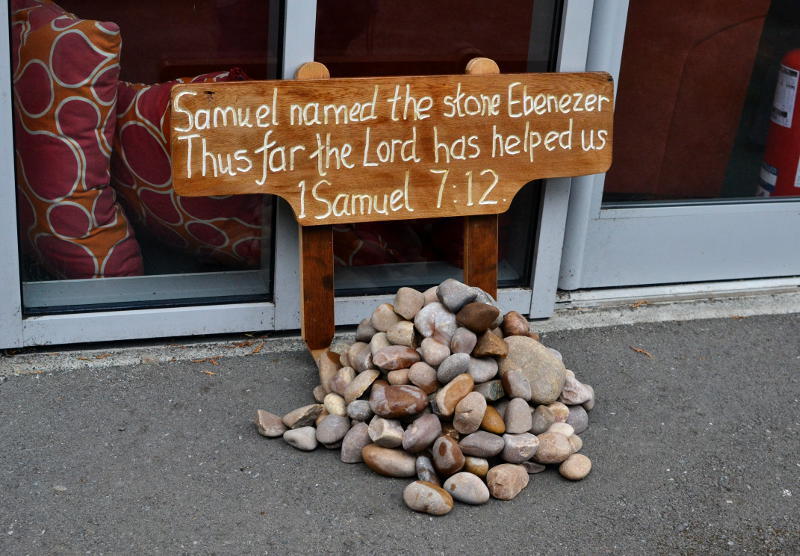 A cairn of stones with a plaque quoting 1 Samuel 7:12