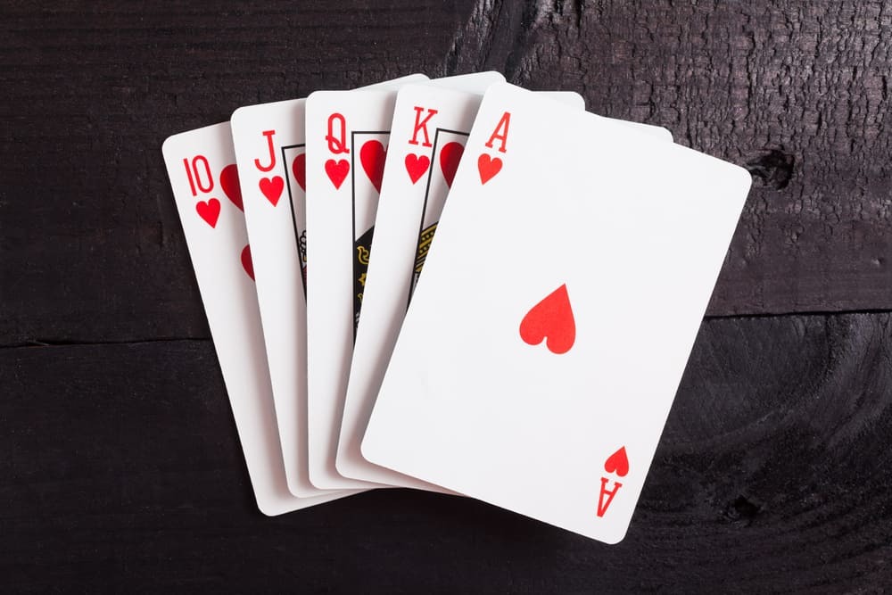 Royal-flush-Playing-cards-isolated-on-a-black...